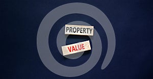 Property value symbol. Concept words Property value on beautiful wooden blocks. Beautiful black table black background. Business