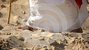 Prophet legs walking on sand, following of Jesus faith, religious conversion photo