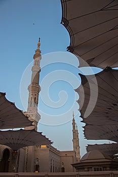 Prophet Mosque in Medina city. View of minarets between canopies. photo