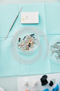 Prophy cups tray, dental spatula and cement lying on table