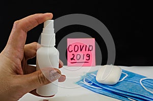 Prophylactic disinfection in hand on the background of masks and soap. Remedies for coronavirus infection.