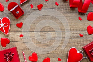 Proposal and engagement concept with romantic border arrangement felt and pillow hearts, red ring box on wooden