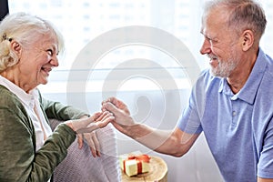 Proposal. senior man making a proposal and a happy woman smiling