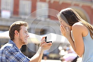 Proposal in the street man asking marry to his girlfriend photo