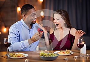 Proposal Surprise. Romantic young black man proposing marriage to his beautiful girlfriend