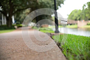 Proposed excavation stake flag utility service beside a footpath and river