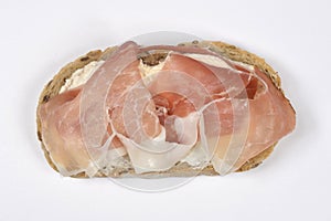 Prosciutto and cream cheese on rustic bread slice