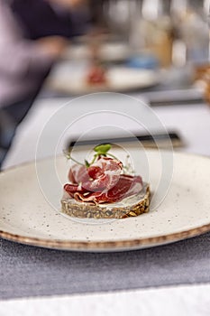 Prosciutto elegantly arranged on a bread