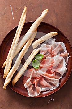 Prosciutto ham and grissini bread sticks. italian antipasto