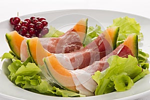 Prosciutto, melon, salad leaf and currants