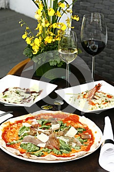 Proscuitto arugula pizza with risotto di gamberi and a chocolate syrup dessert photo