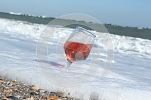 Proseco. Glasses with Proseco on a beach with seashells.