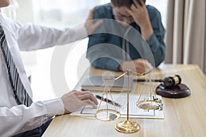 Prosecutor or lawyer comforts a client who is worried about a fraudulent business