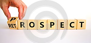 Prospect or retrospect symbol. Businessman turns a cube and changes the word `retrospect` to `prospect`. Beautiful white