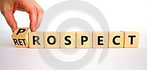 Prospect or retrospect symbol. Businessman turns a cube and changes the word `retrospect` to `prospect`. Beautiful white photo