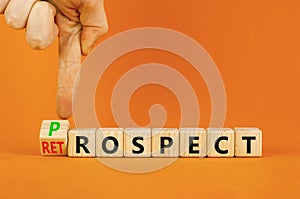 Prospect or retrospect symbol. Concept word Retrospect or Prospect on beautiful wooden cubes. Beautiful orange background. photo