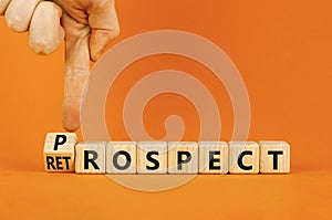 Prospect or retrospect symbol. Concept word Retrospect or Prospect on beautiful wooden cubes. Beautiful orange background. photo