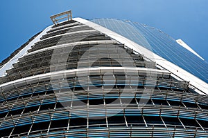 Prospective view to new modern building. Modern office building with glass facade on clear sky background