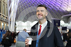 Prosperous businessman smiling in the crowd photo