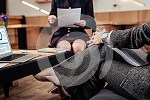 Prosperous businesswoman wearing hand watch talking to secretary