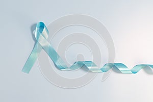 Prostate cancer awareness campaign concept, Men`s health concept. light blue ribbon long tail on blue background. Symbol for