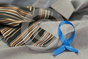 Prostate cancer awareness concept with light blue ribbon on necktie