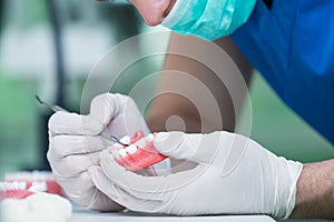 Prosthetics hands while working on the denture. photo