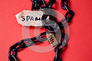 Protect from junk mail or spam e-mail and unsolicited letter. The word spam and the lock on the chain photo
