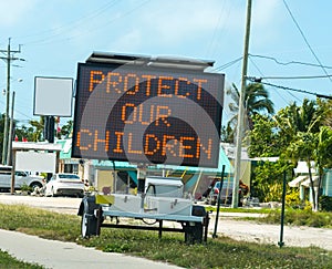 Protect our children sign on the edge of the road