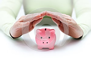 Protect your savings - with hands and piggy bank