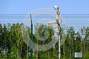 Protected area. Surveillance cameras for surveillance. CCTV footage from our property. Fence