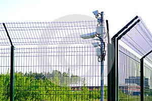 Protected area. Surveillance cameras for surveillance. CCTV footage from our property. Fence