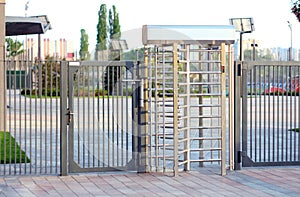 Protected entrance gate.Entrance to office through big in full human growth stainless steel turnstiles. Concept of security, lock