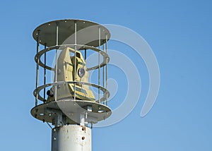 Protected outdoor security camera against a blue sky. opy space