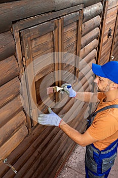 Protecting wooden house exterior with applying stain or paint