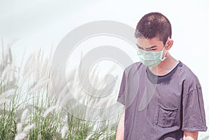 Protection against contagious disease, coronavirus. Asian young boy wearing hygienic mask to prevent infection