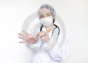 Dotkor woman in white coat, gloves and mask. Protection against infections during the COVID epidemic. Medicine and photo