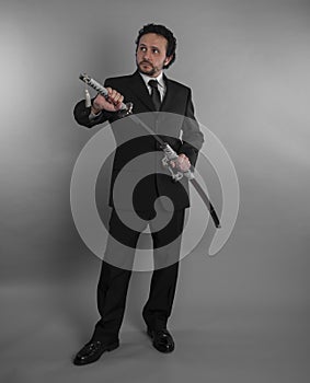 Protection, Aggressive businessman with Japanese swords in defensive and defensive pose