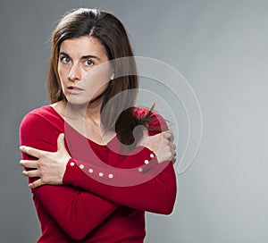 Protection concept for critical 30s woman with arms crossed