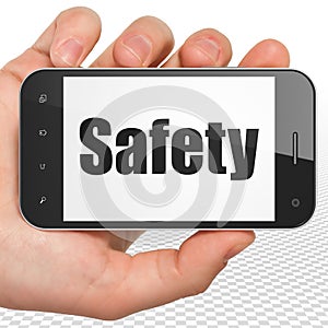 Protection concept: Hand Holding Smartphone with Safety on display