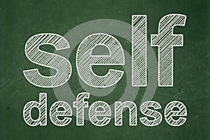 Protection concept: Self Defense on chalkboard background