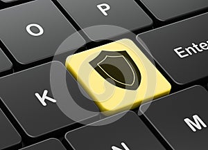 Protection concept: Shield on computer keyboard background