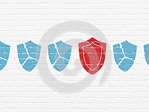 Protection concept: shield icon on wall background