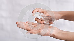 Protection from coronavirus. Woman sprays antiseptics on her hands.