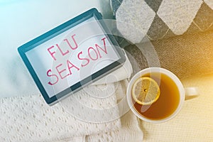 Protection from flu season - warm woolen clothing and lot of hot drinks. Flu season - text in frame.