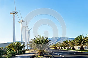 Protection of nature. Wind turbines against mountains and near road.