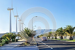 Protection of nature. Wind turbines against mountains and near road.