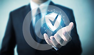 Protection network security computer and safe your data concept, Businessman holding shield icon