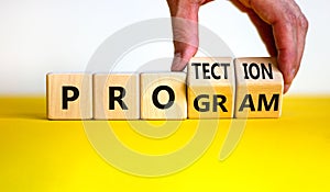 Protection program symbol. Businessman turns wooden cubes and changes the word `program` to `protection`. Beautiful yellow tab