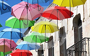 Protection for a rainy day with flying umbrellas in a summer street festival